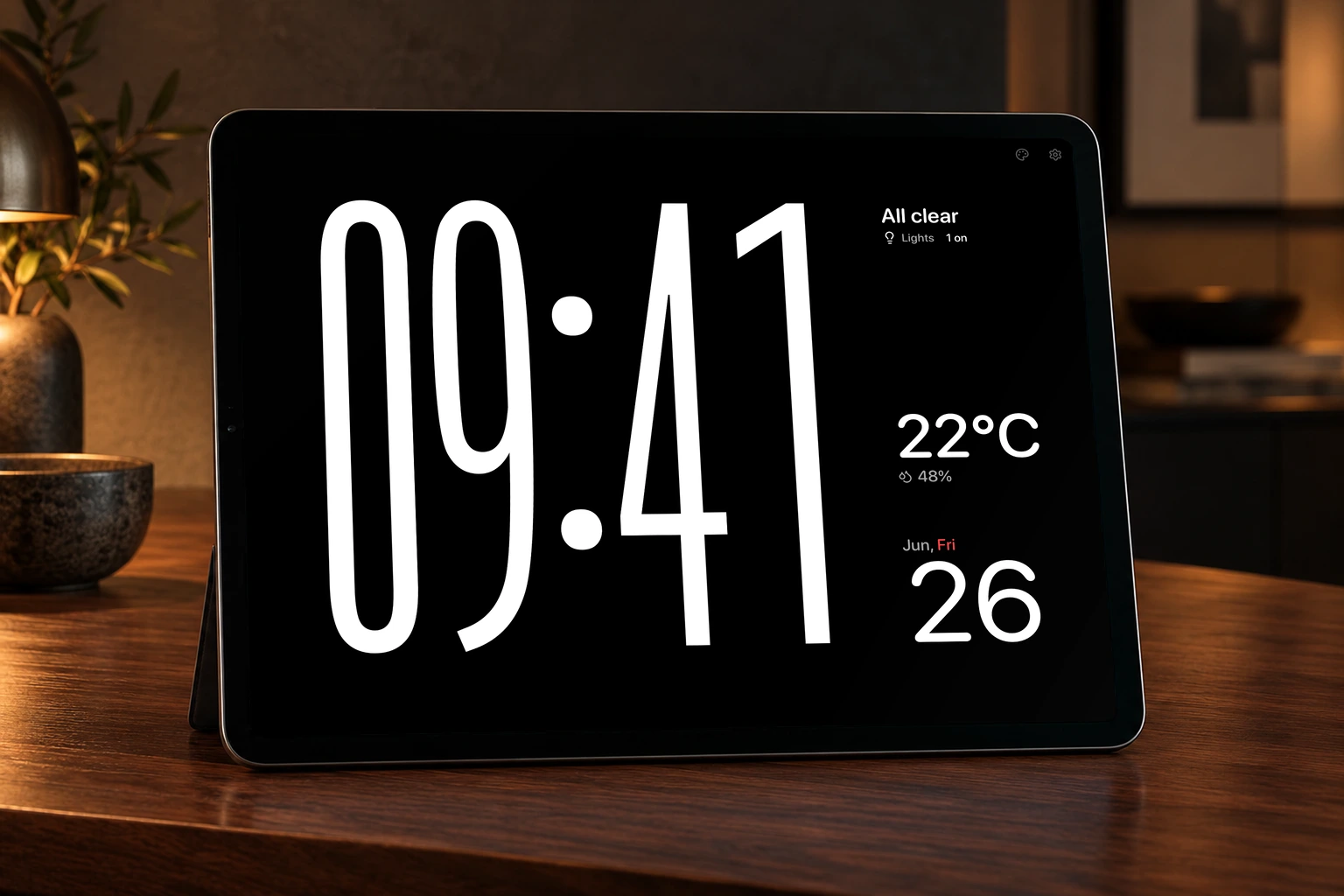 Hearth Modular screensaver on an iPad on a walnut counter, with a digital clock, home status, indoor climate, and date calendar